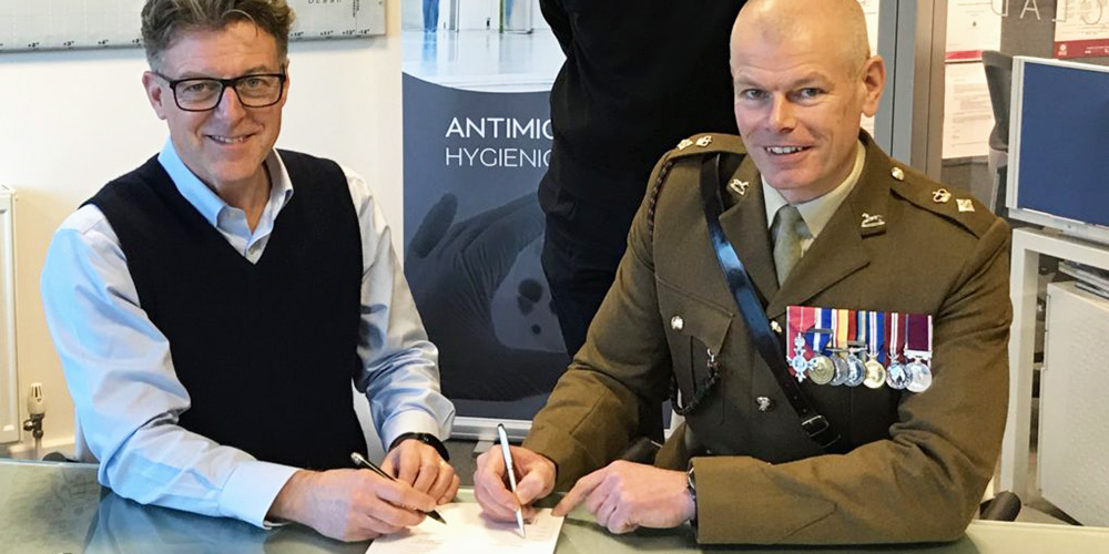BioClad Managing Director Lindsay McKenzie signing the Armed Forces Covenant